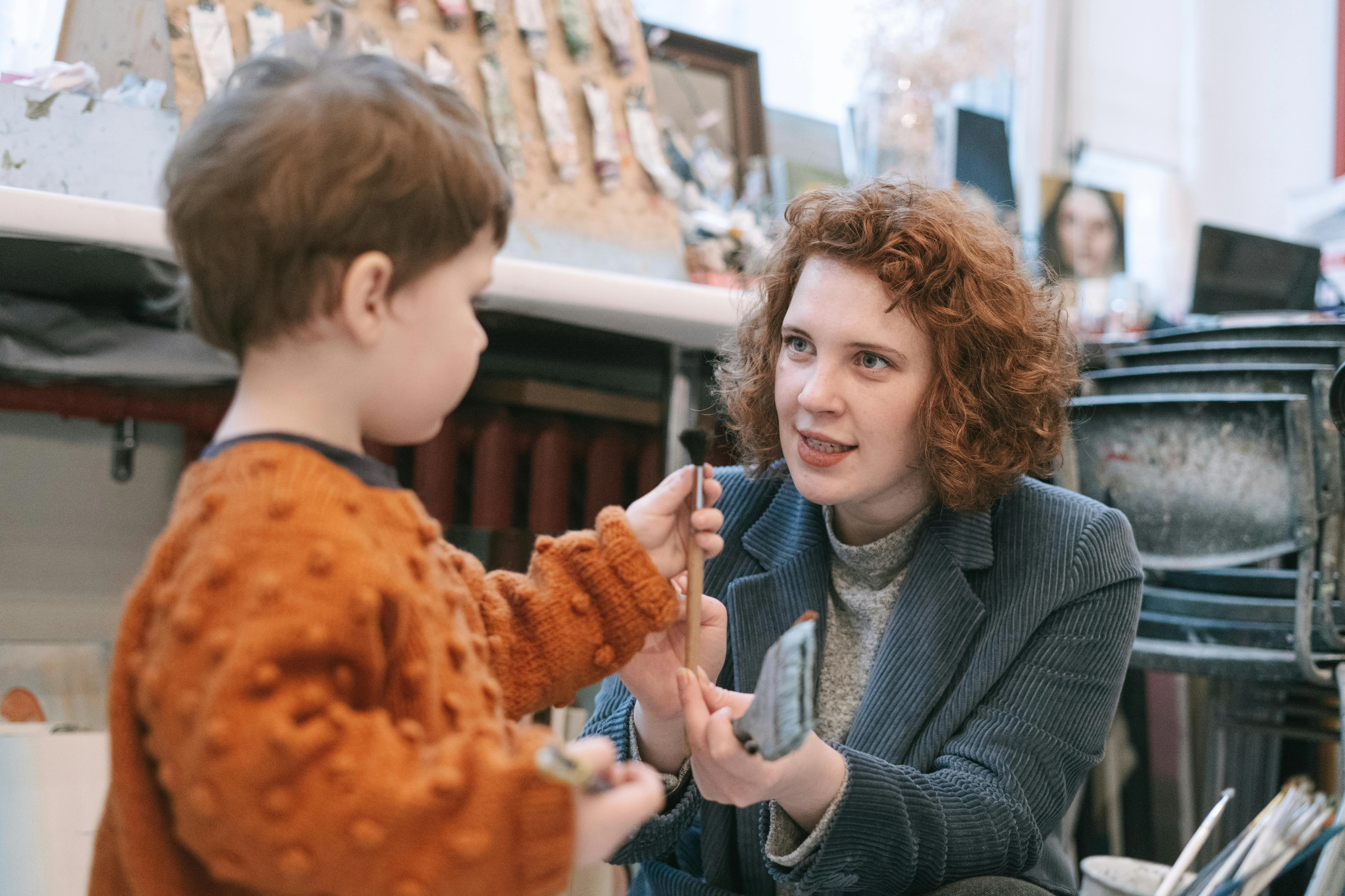 Adult working one-on-one with a young child in a warm, supportive learning environment