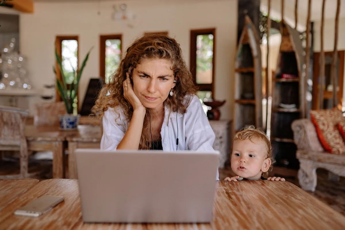 A parent and an IEP advocate comparing options on a laptop at a tidy desk