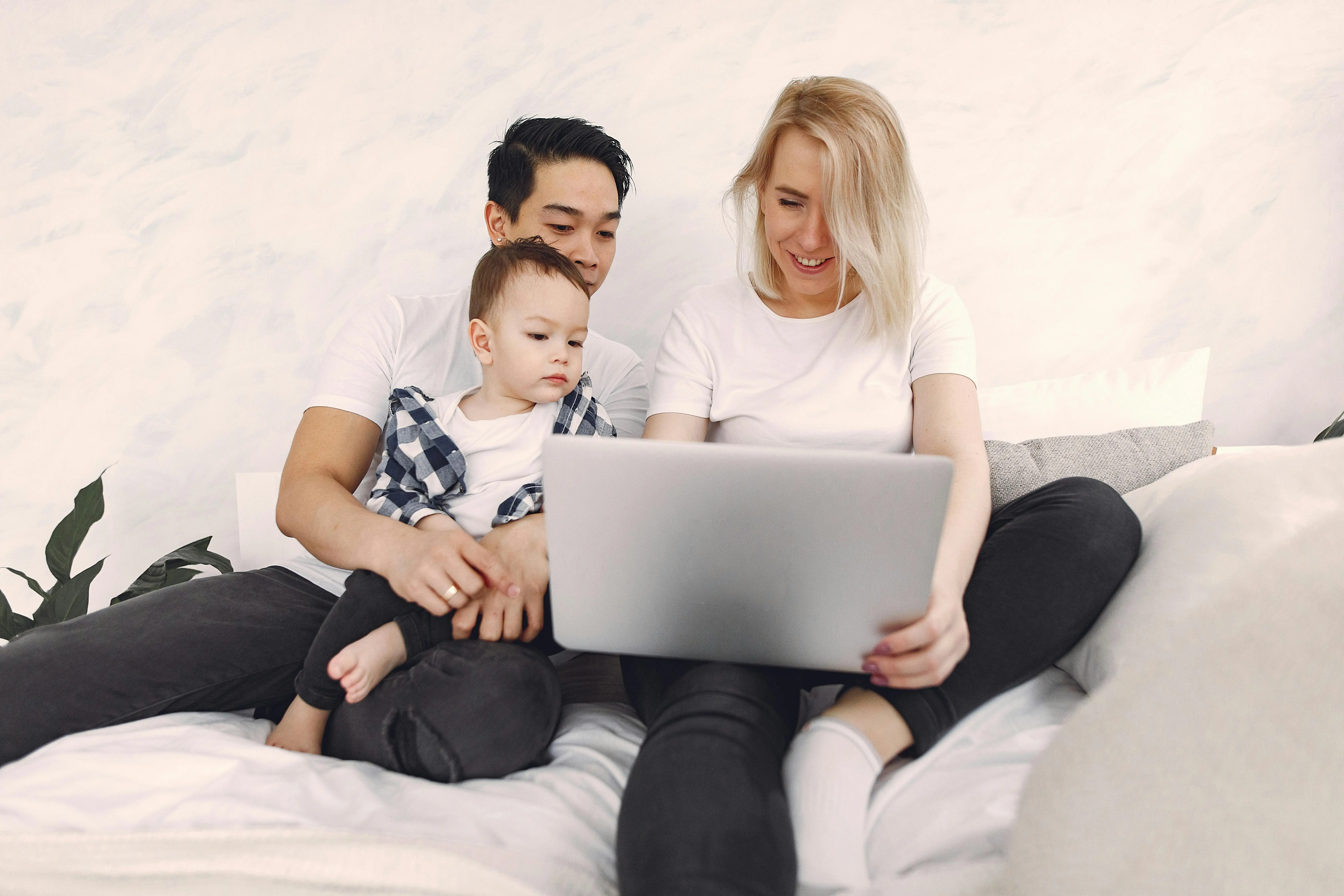 Mixed-race family reviewing documents together on laptop