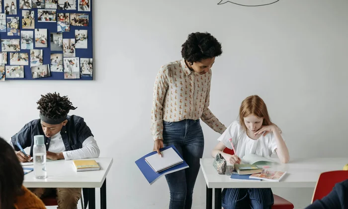 Teacher supporting students in inclusive classroom