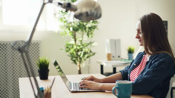 A parent comparing IEP tools on a laptop at a home desk