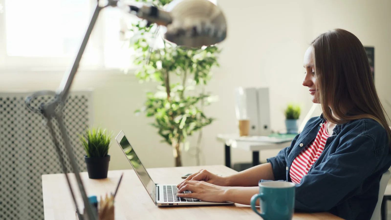 A parent comparing IEP tools on a laptop at a home desk