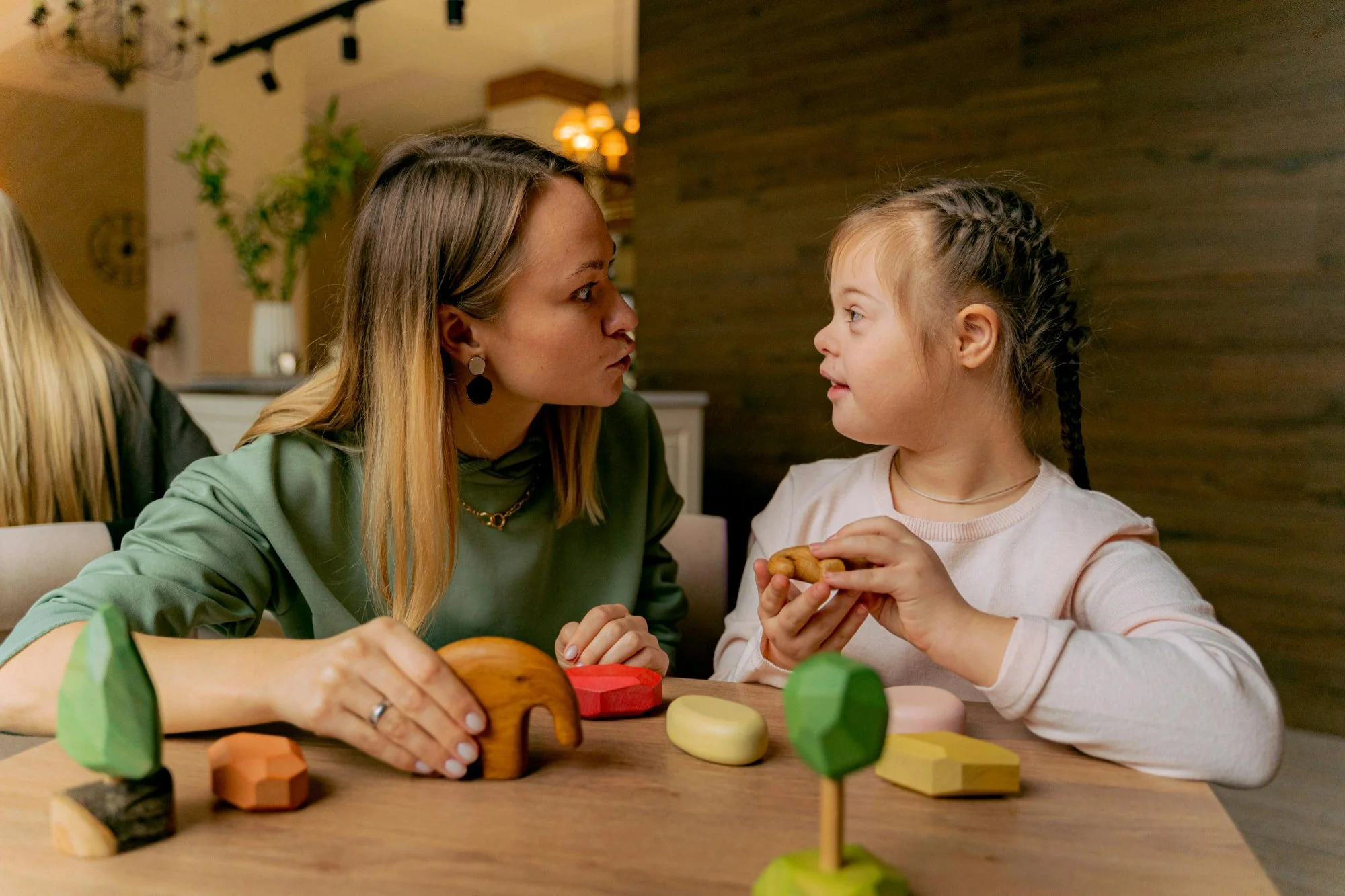 Child with a disability being supported by a teacher in an inclusive general education classroom setting