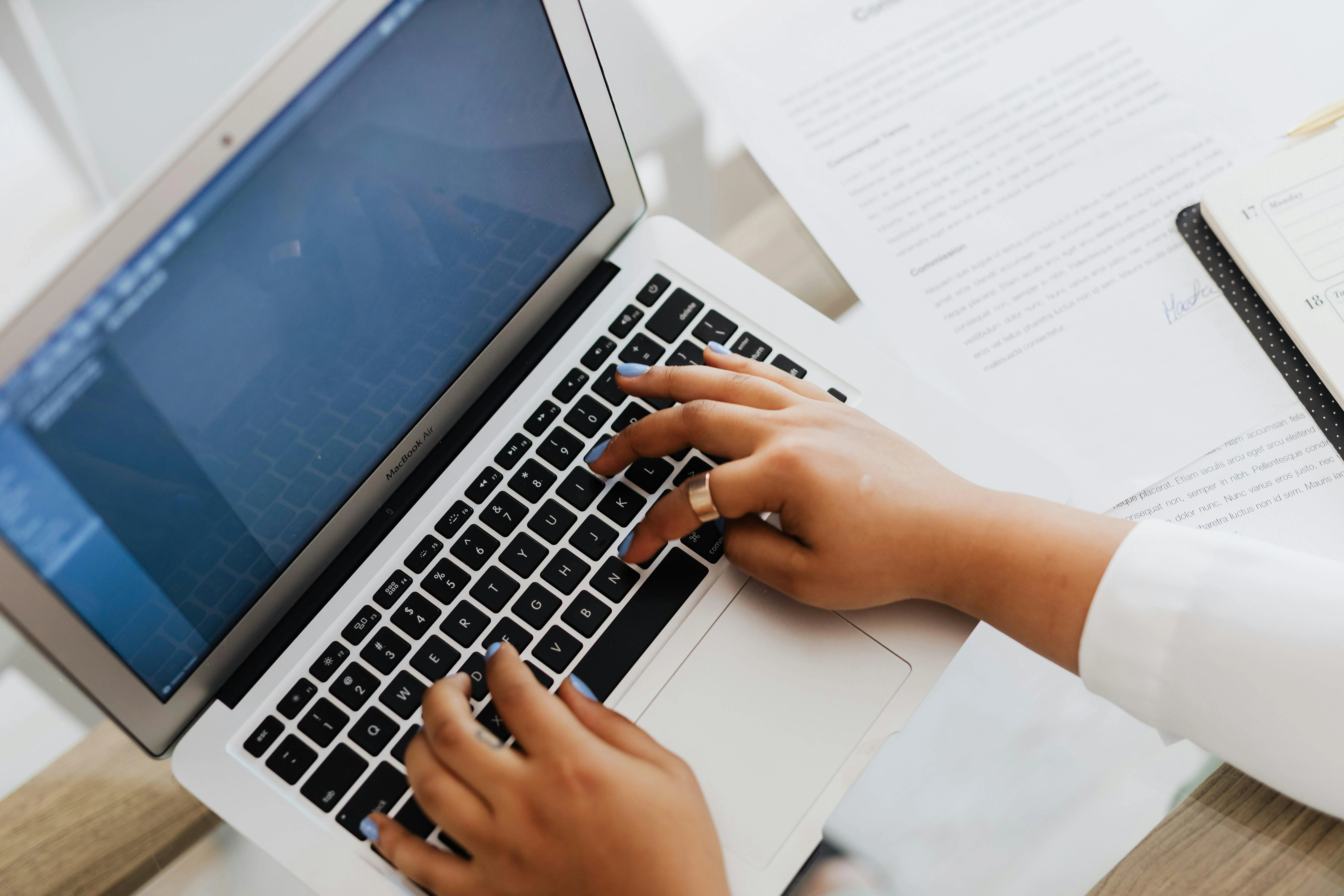 Parent tracking IEP goal progress on laptop with documents